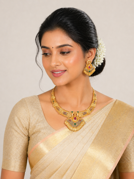 Gold plated necklace set with central pendant with red and green gemstone
