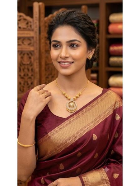 Elegant gold-tone necklace with a beautifully crafted circular pendant and textured bead accents. A timeless statement piece, perfect for weddings, festive occasions, and everyday elegance.
