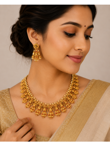 Antique gold temple necklace with pearl detailing and matching earrings.