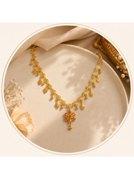 Elegant gold-tone necklace featuring delicate dangling motifs and a vibrant floral pendant for a graceful traditional look