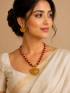 Antique gold temple necklace with red beads and matching earrings.