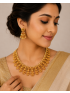 Antique gold temple necklace with pearl detailing and matching earrings.