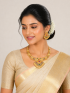 Gold plated necklace set with central pendant with red and green gemstone