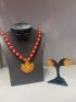 Antique gold temple necklace with red beads and matching earrings.