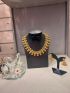 Antique gold temple necklace with pearl detailing and matching earrings.