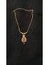 Elegant gold-tone necklace featuring a delicate floral pendant with intricate detailing. Perfect for adding timeless elegance to both everyday wear and special occasions.