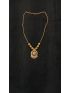 Elegant gold-tone necklace with a beautifully crafted circular pendant and textured bead accents. A timeless statement piece, perfect for weddings, festive occasions, and everyday elegance.