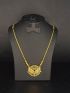 Elegant gold-tone necklace featuring a dazzling stone-studded floral pendant with delicate dangling accents for a graceful finish