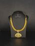 Elegant gold-tone necklace featuring a sparkling stone-studded pendant with intricate traditional detailing.