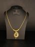 Elegant gold-tone necklace featuring an intricately crafted peacock-inspired pendant with sparkling stone detaili