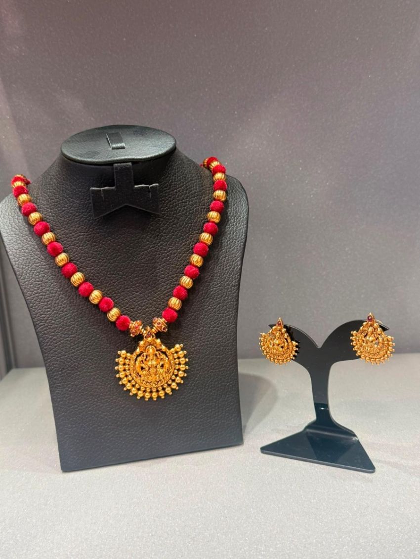Antique gold temple necklace with red beads and matching earrings.