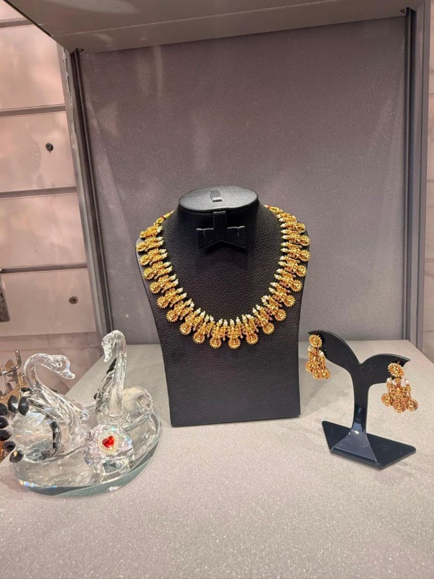 Antique gold temple necklace with pearl detailing and matching earrings.