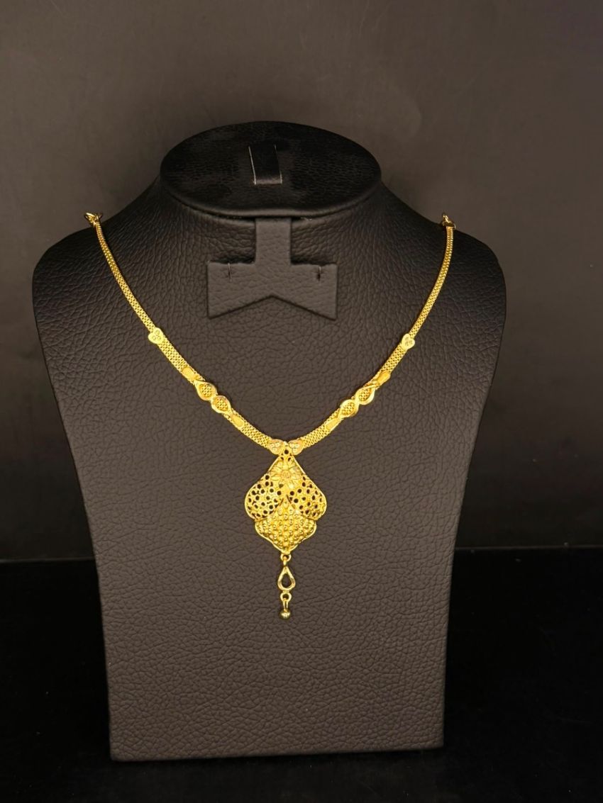 Elegant gold-tone necklace featuring a beautifully detailed filigree pendant with a graceful drop charm for a timeless finish